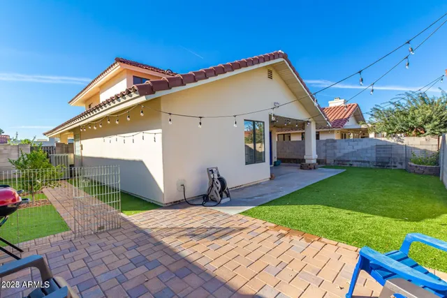 a front view of house with a garden and patio