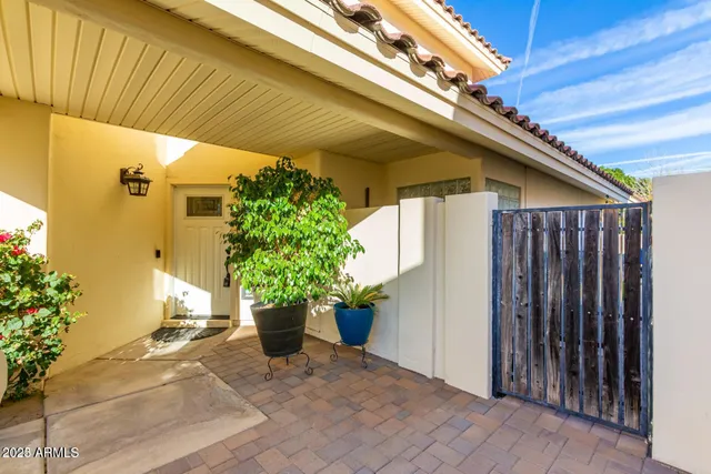 a view of a porch with potted plants