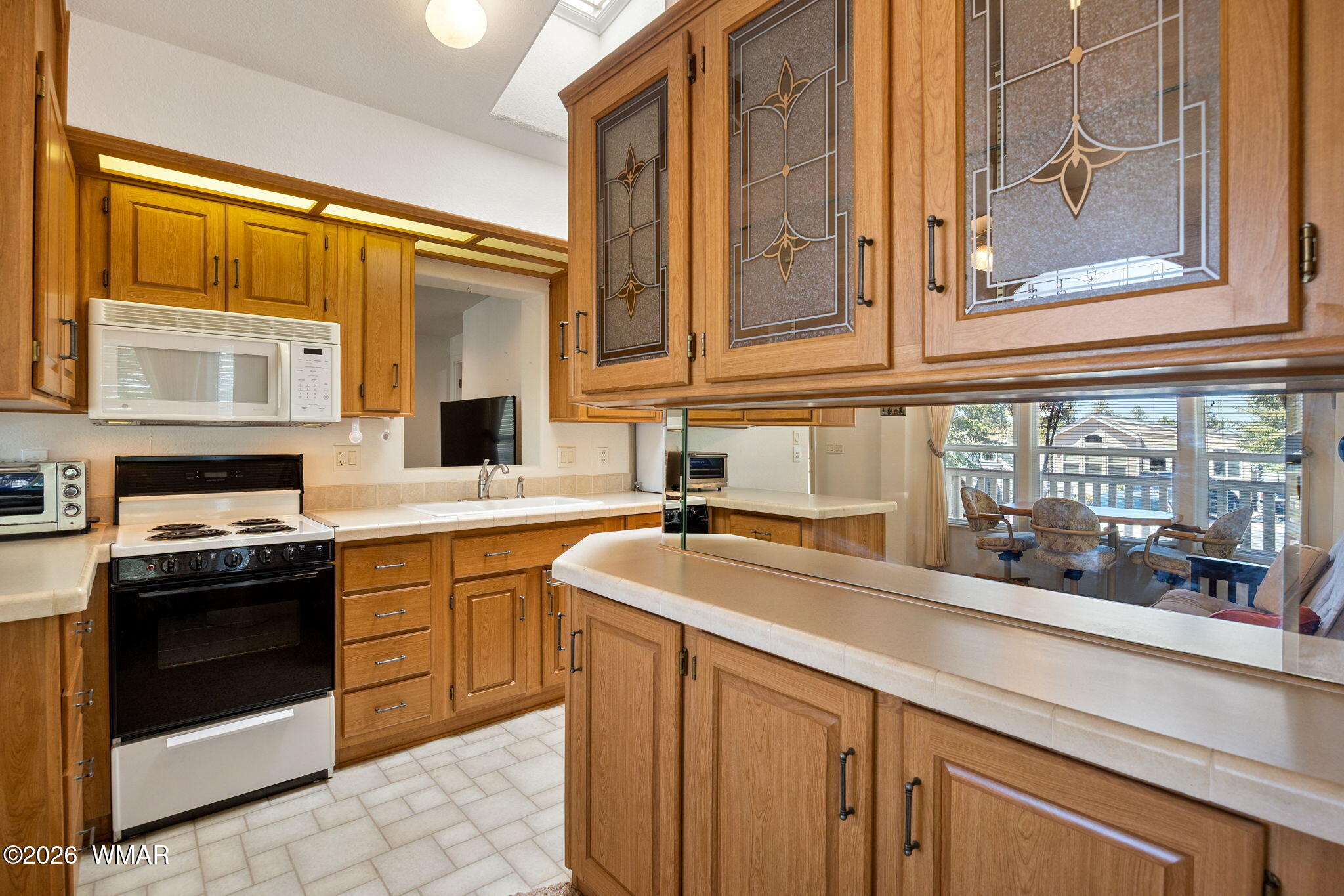 2221 Wrangler Way Overgaard, AZ 85933 - Photo 13 of 24 a kitchen with stainless steel appliances granite countertop a sink and a stove