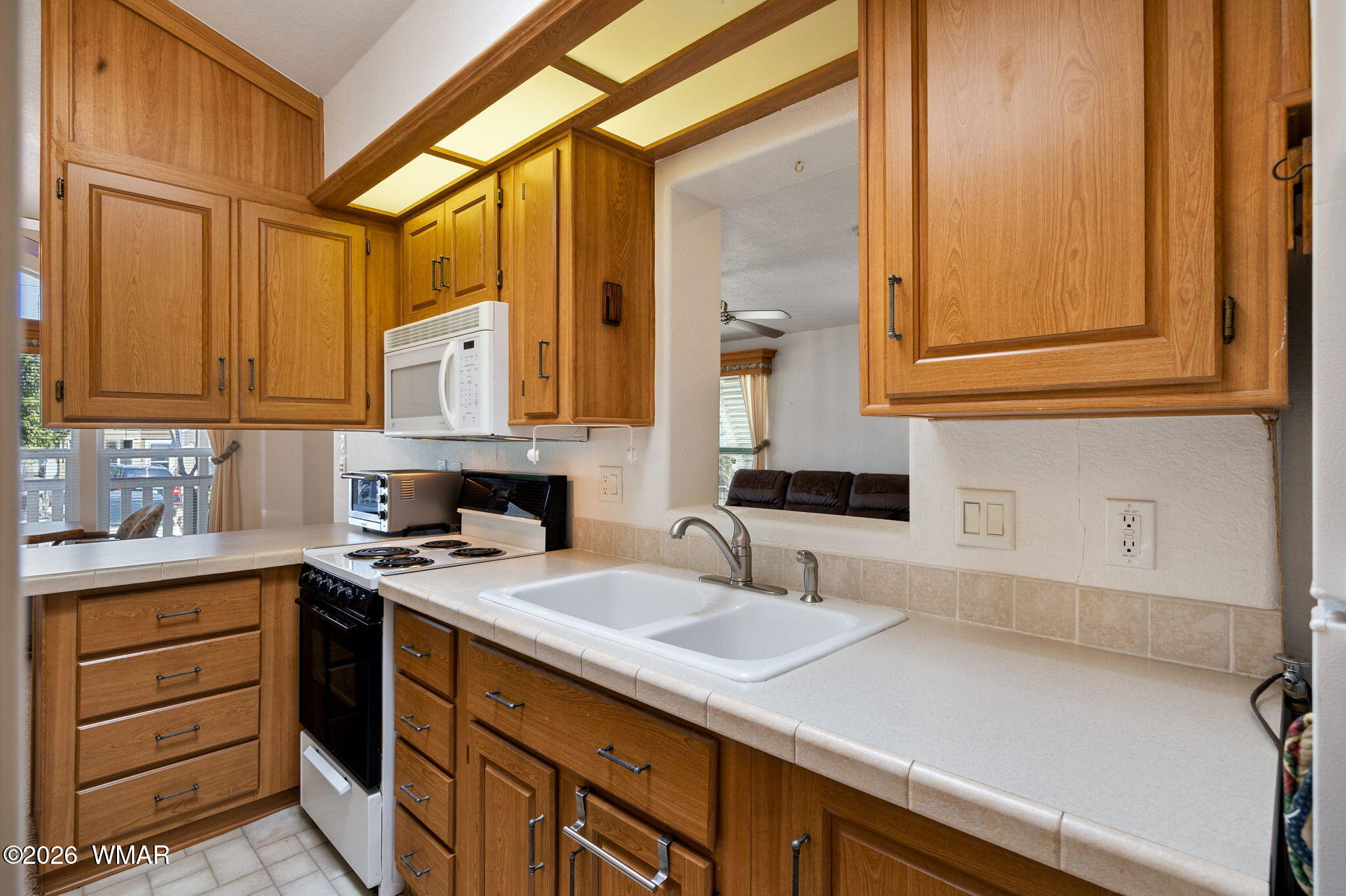 2221 Wrangler Way Overgaard, AZ 85933 - Photo 14 of 24 a kitchen with a sink and cabinets