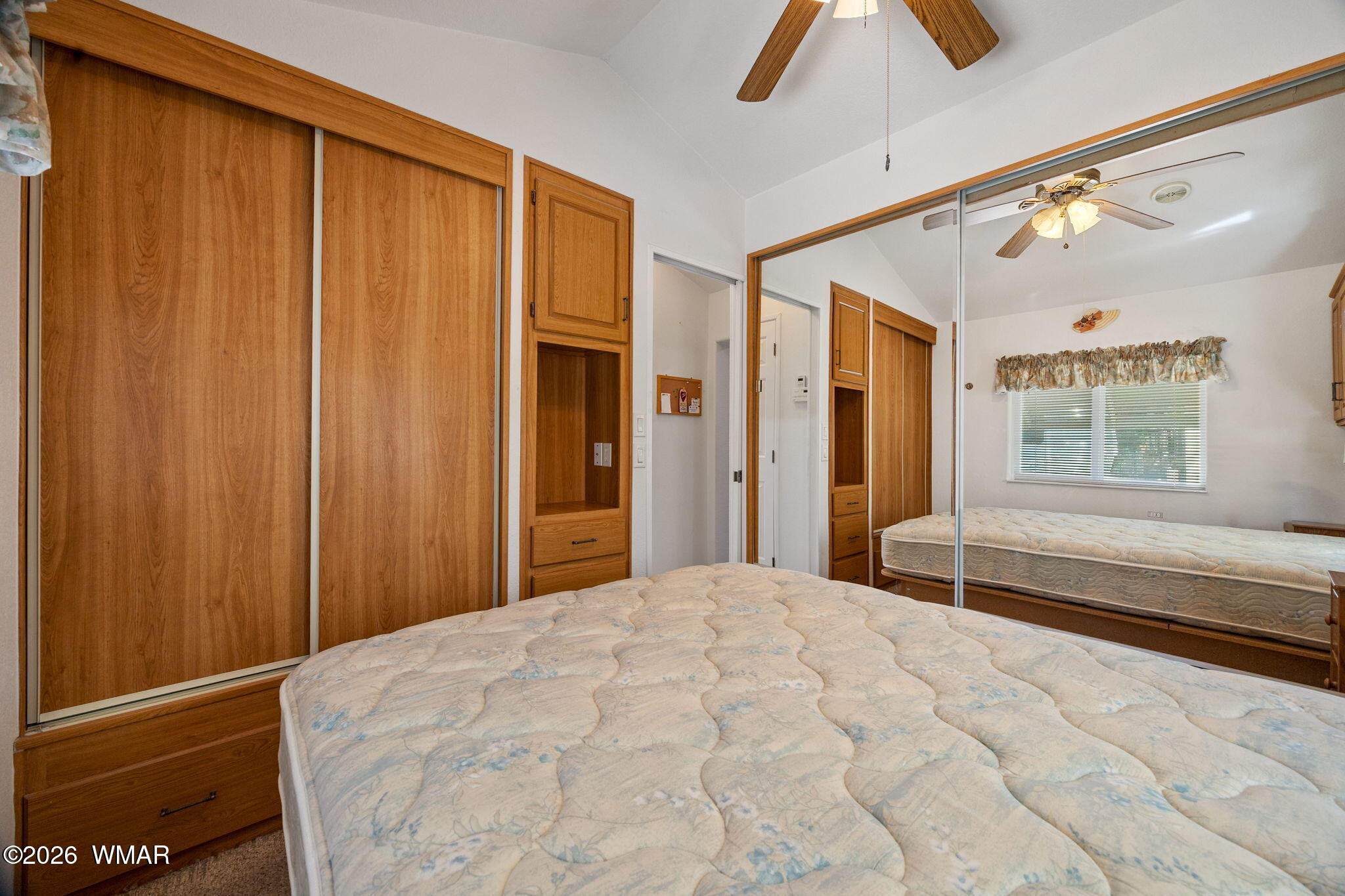 2221 Wrangler Way Overgaard, AZ 85933 - Photo 16 of 24 a bedroom with a large bed and a chandelier