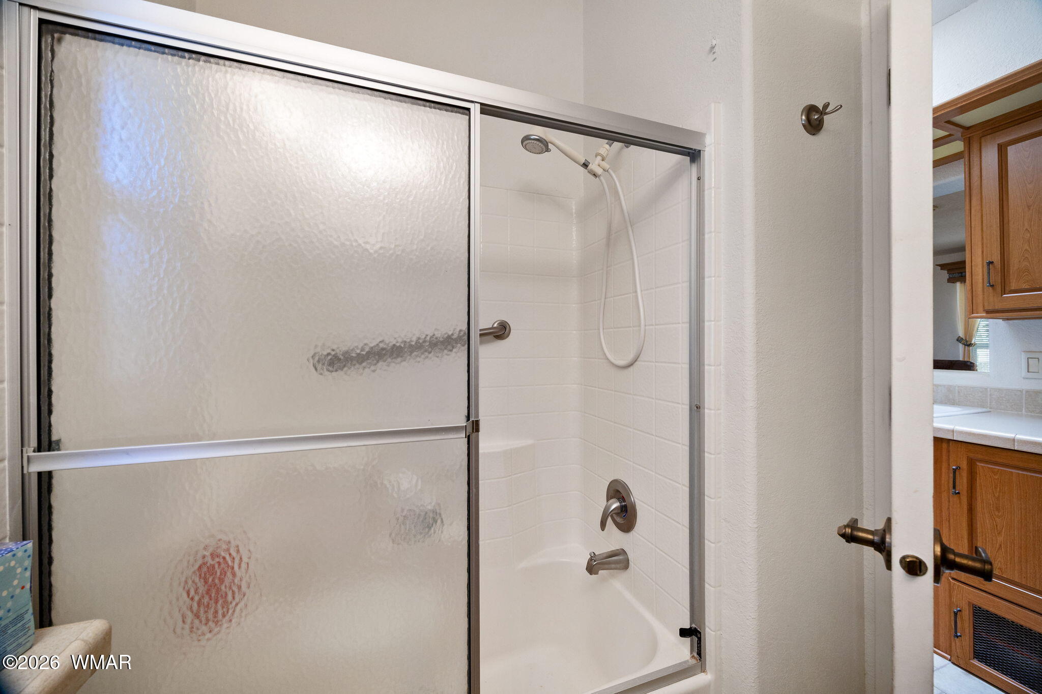 2221 Wrangler Way Overgaard, AZ 85933 - Photo 18 of 24 a bathroom with a shower and a glass shower door
