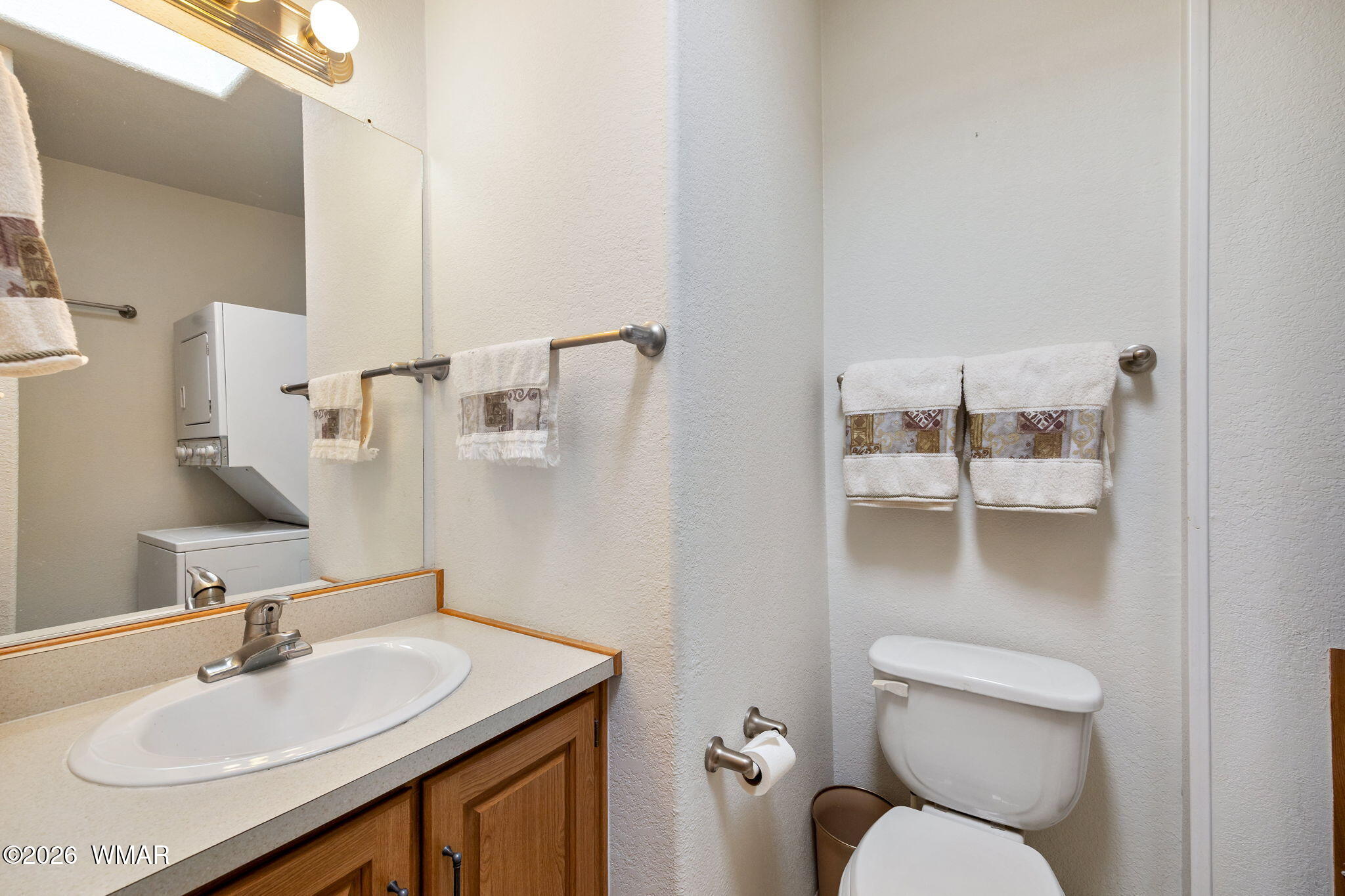 2221 Wrangler Way Overgaard, AZ 85933 - Photo 20 of 24 a bathroom with a sink toilet and a mirror