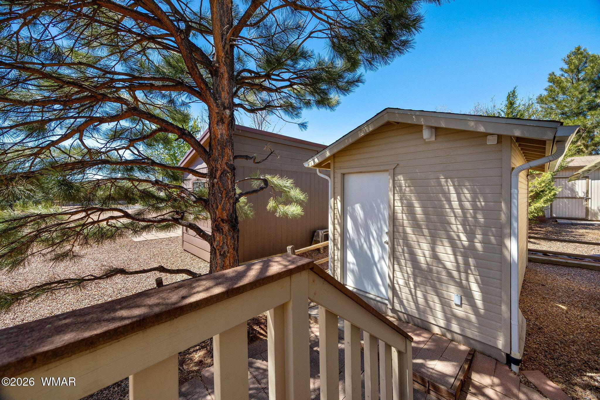 2221 Wrangler Way Overgaard, AZ 85933 - Photo 22 of 24 a front view of a house with garden