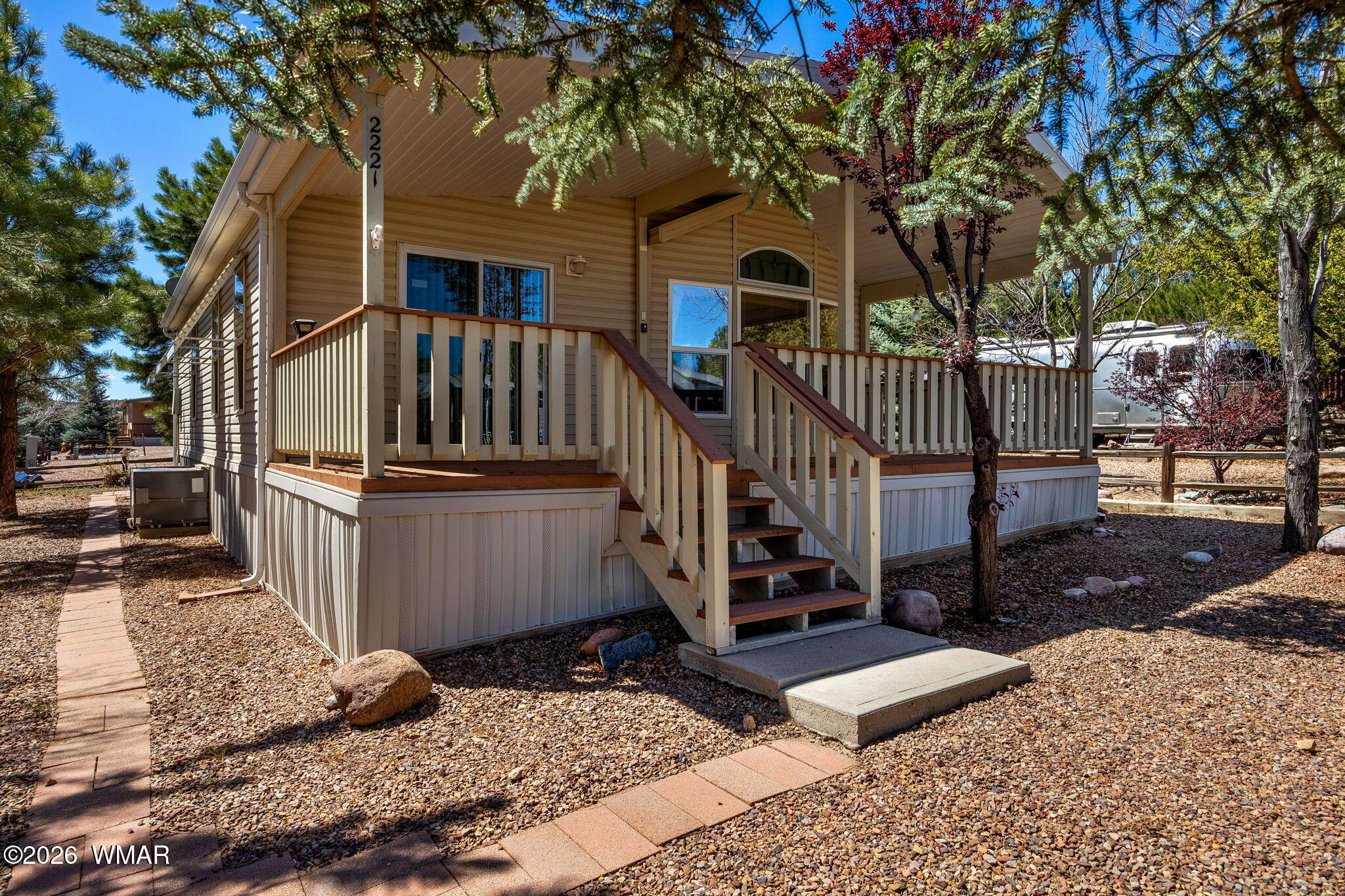 2221 Wrangler Way Overgaard, AZ 85933 - Photo 5 of 24 a view of a house with wooden fence next to a road