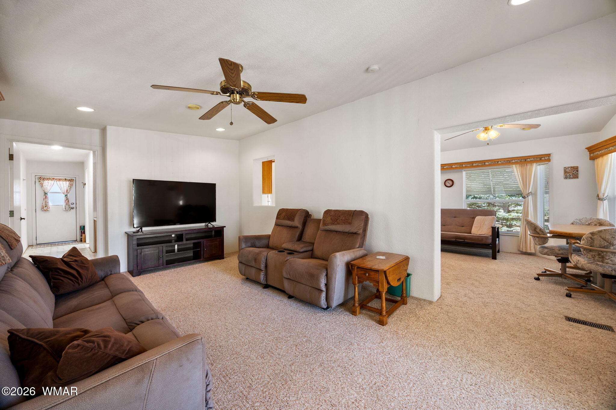2221 Wrangler Way Overgaard, AZ 85933 - Photo 8 of 24 a living room with furniture a flat screen tv and a window