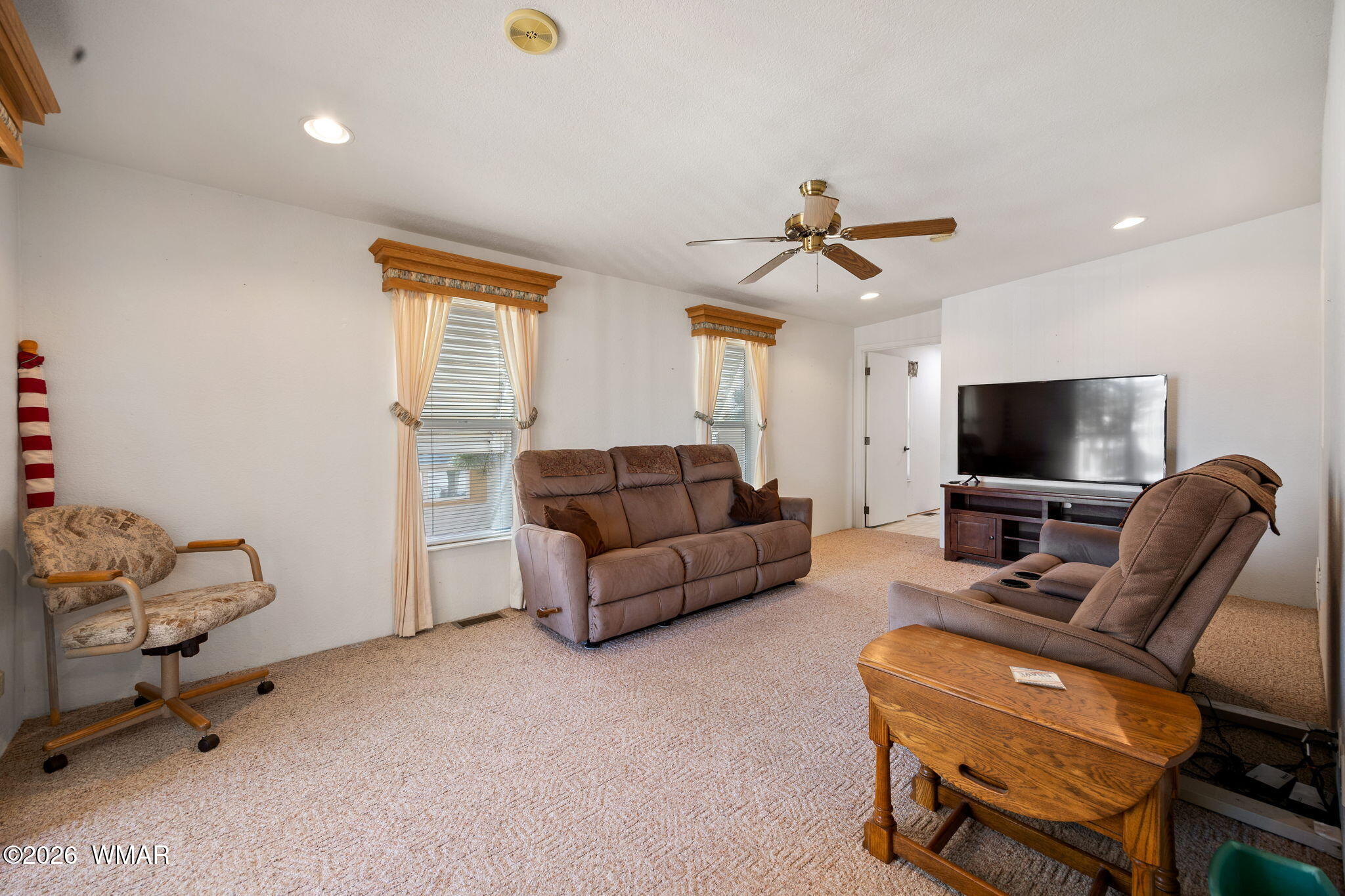 2221 Wrangler Way Overgaard, AZ 85933 - Photo 10 of 24 a living room with furniture and a flat screen tv