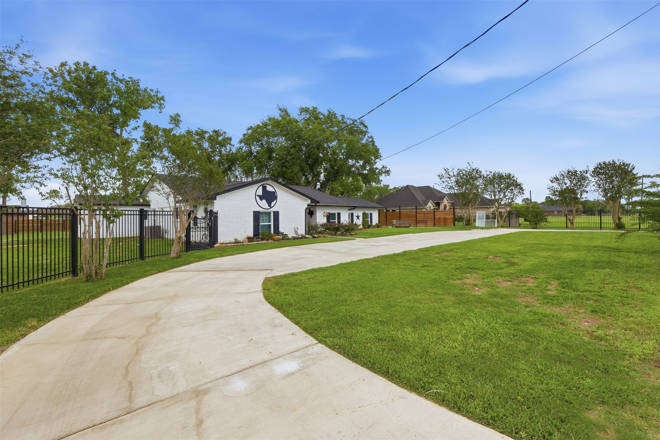5111 Brookside Road Pearland, TX 77581 - Photo 31 of 42 Additional exterior angle showcasing the gated entry, circular drive, and impressive one acre setting.