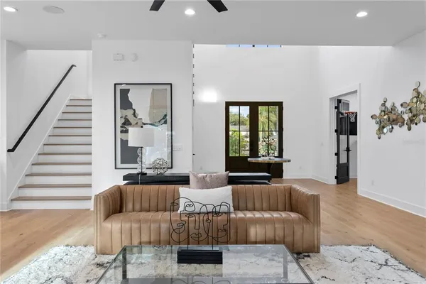 a kitchen with stainless steel appliances granite countertop a sink a stove a refrigerator and chairs