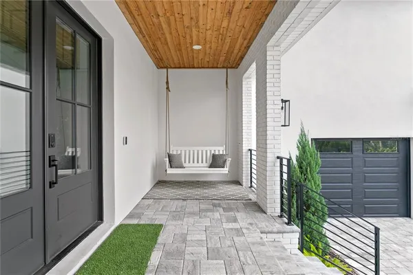 a view of a house with a small yard and wooden floor and fence