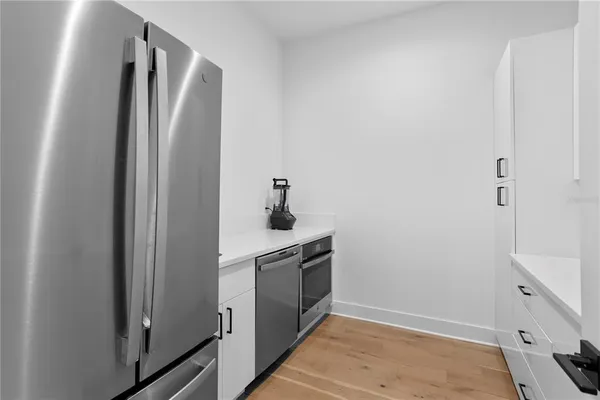 a spacious bathroom with double vanity a mirror and a shower
