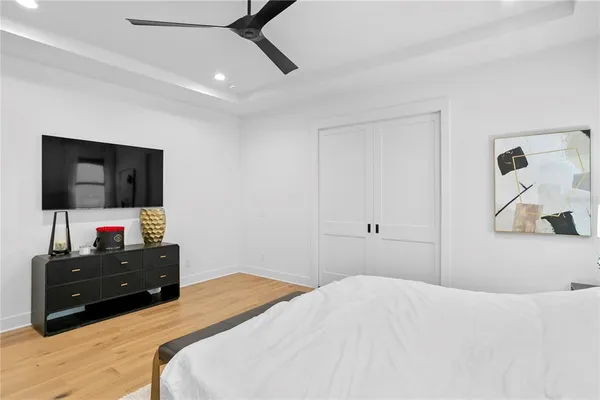 a bedroom with a bed and a television