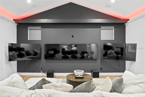 a living room with furniture a chandelier and a floor to ceiling window