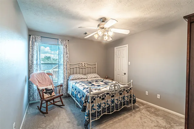 a bedroom with a bed chairs and a chandelier