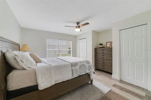 a bedroom with a bed dresser and a window