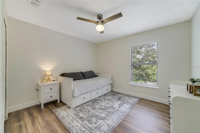 a living room with a bed and a window
