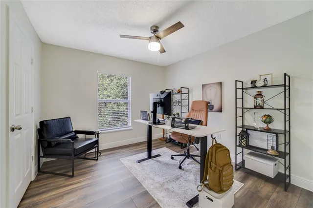 a workspace with wooden floor and a window