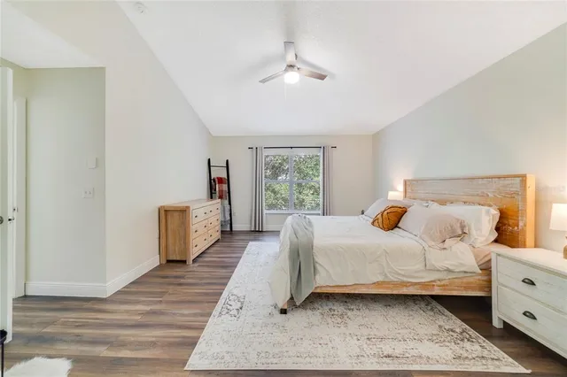 a bedroom with a large bed and a window