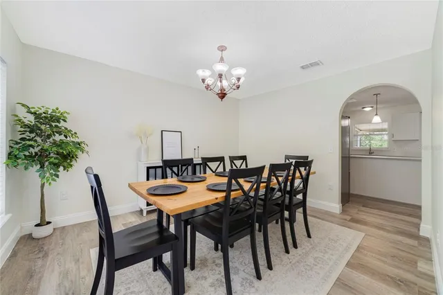 a view of a dining room with furniture and chandelier