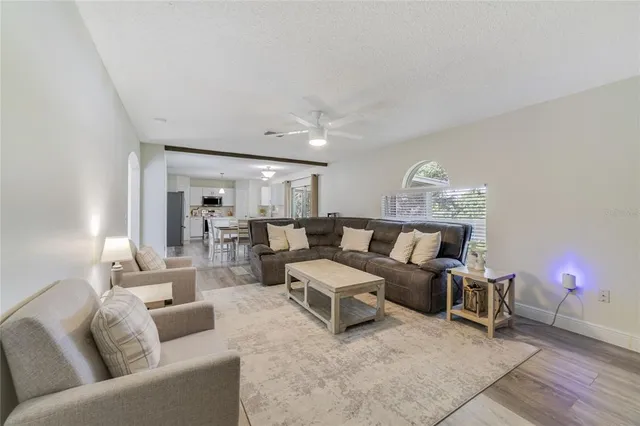 a living room with furniture and wooden floor