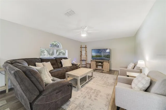 a living room with furniture and a lamp