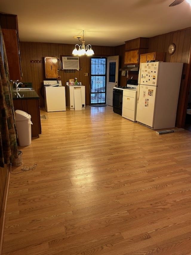 7030 Asbury Glimp Road Ripley, TN 38063 - Photo 7 of 17 Kitchen featuring freestanding refrigerator, washer / clothes dryer, gas stove, wooden walls, and a chandelier
