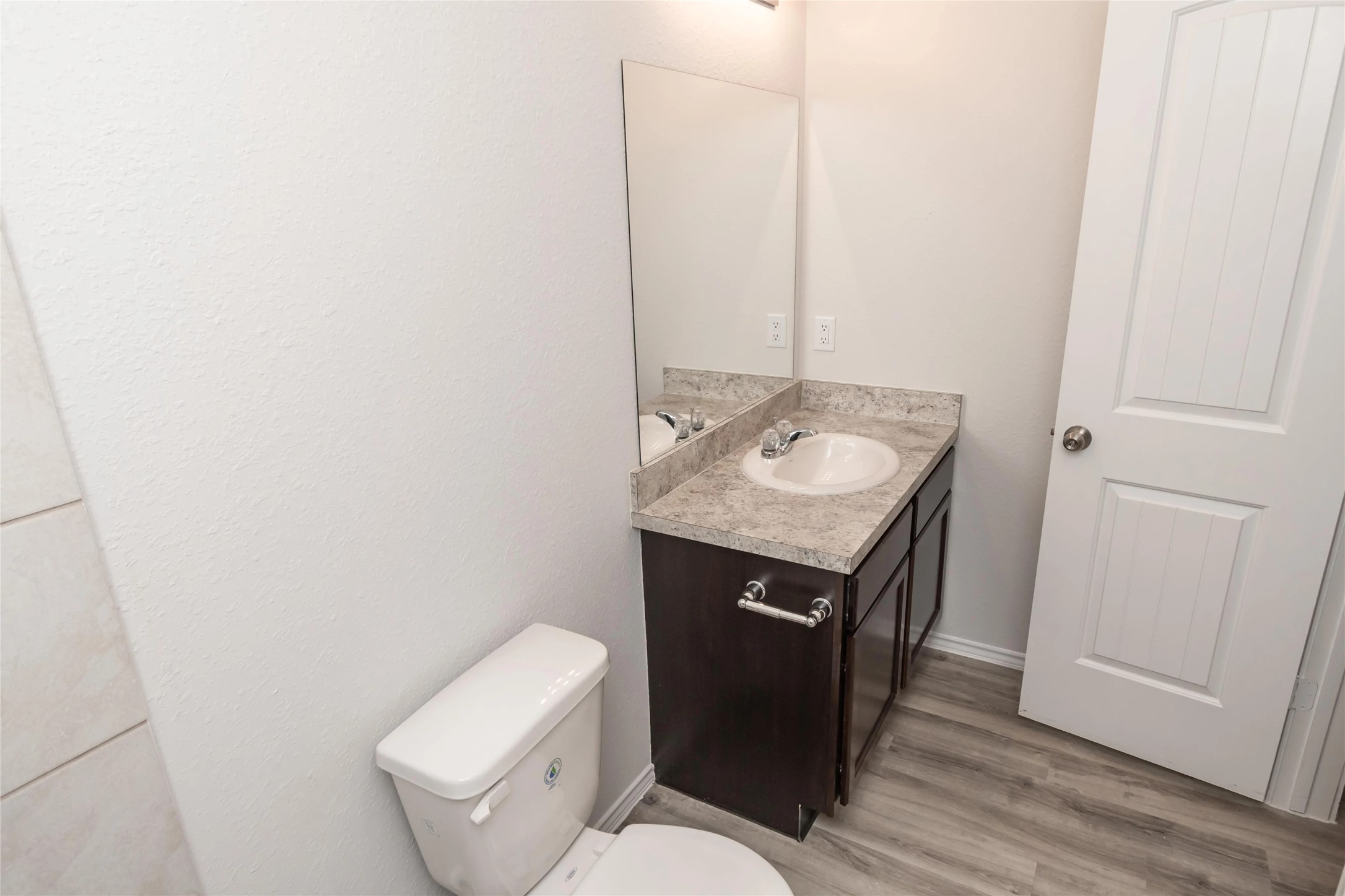 8711 Lar Ree Oaks Circle Houston, TX 77028 - Photo 6 of 8 a bathroom with a granite countertop toilet sink and mirror