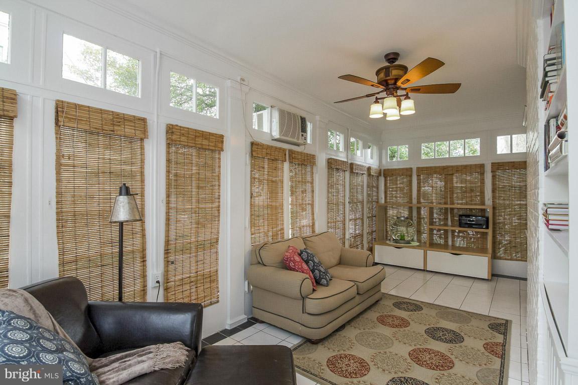 6209 Pinehurst Road Baltimore, MD 21212 - Photo 8 of 29 a living room with furniture and a floor to ceiling window