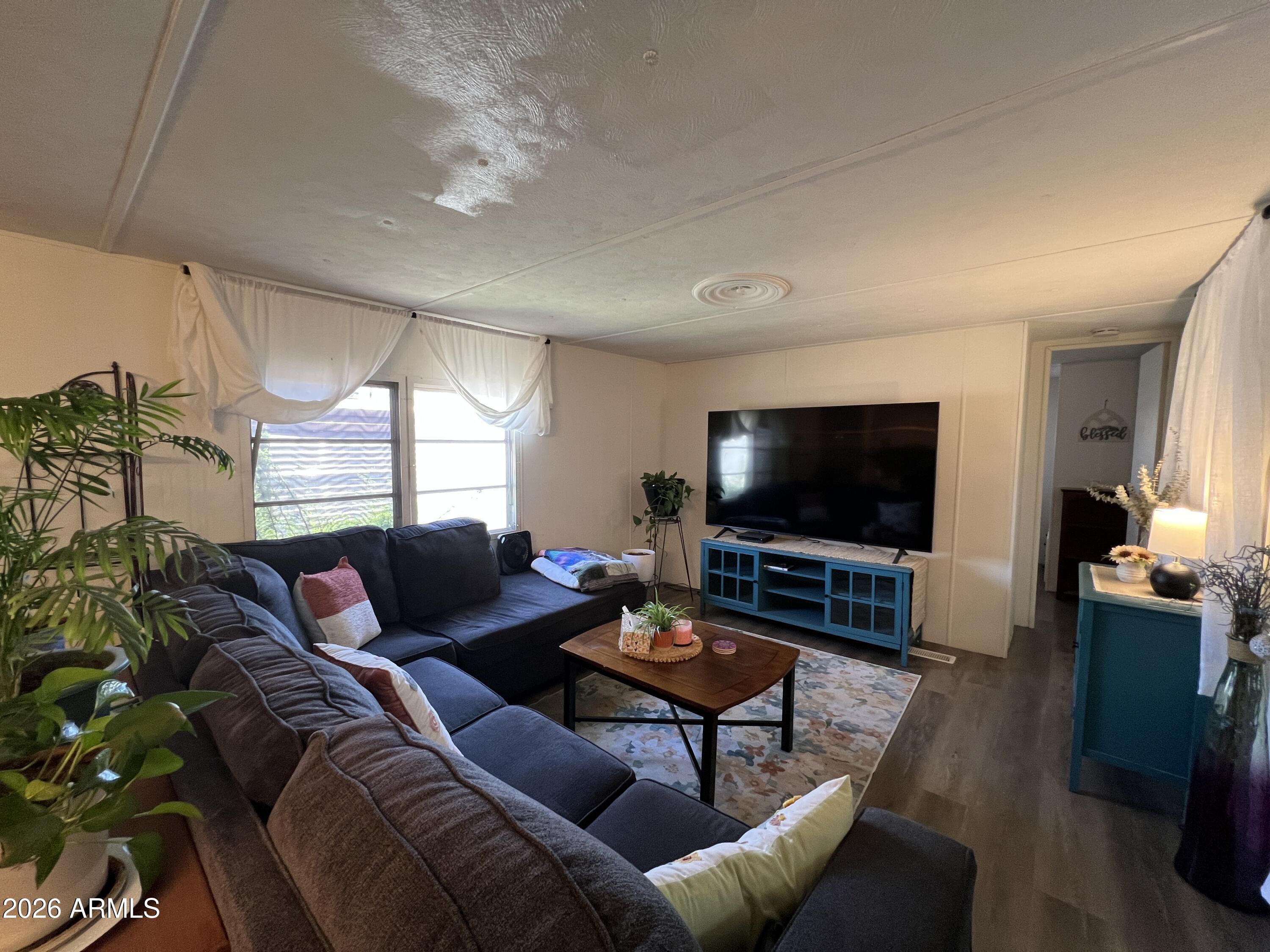 19225 North Cave Creek Road, Unit 40 Phoenix, AZ 85024 - Photo 9 of 21 a living room with furniture and a flat screen tv