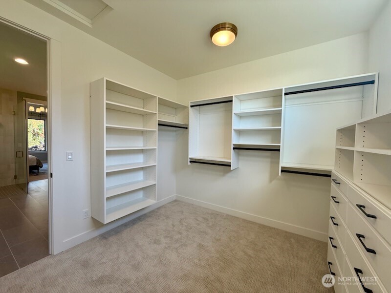 12107 Mundy Loss Road Buckley, WA 98321 - Photo 23 of 40 a view of walk in closet with empty racks