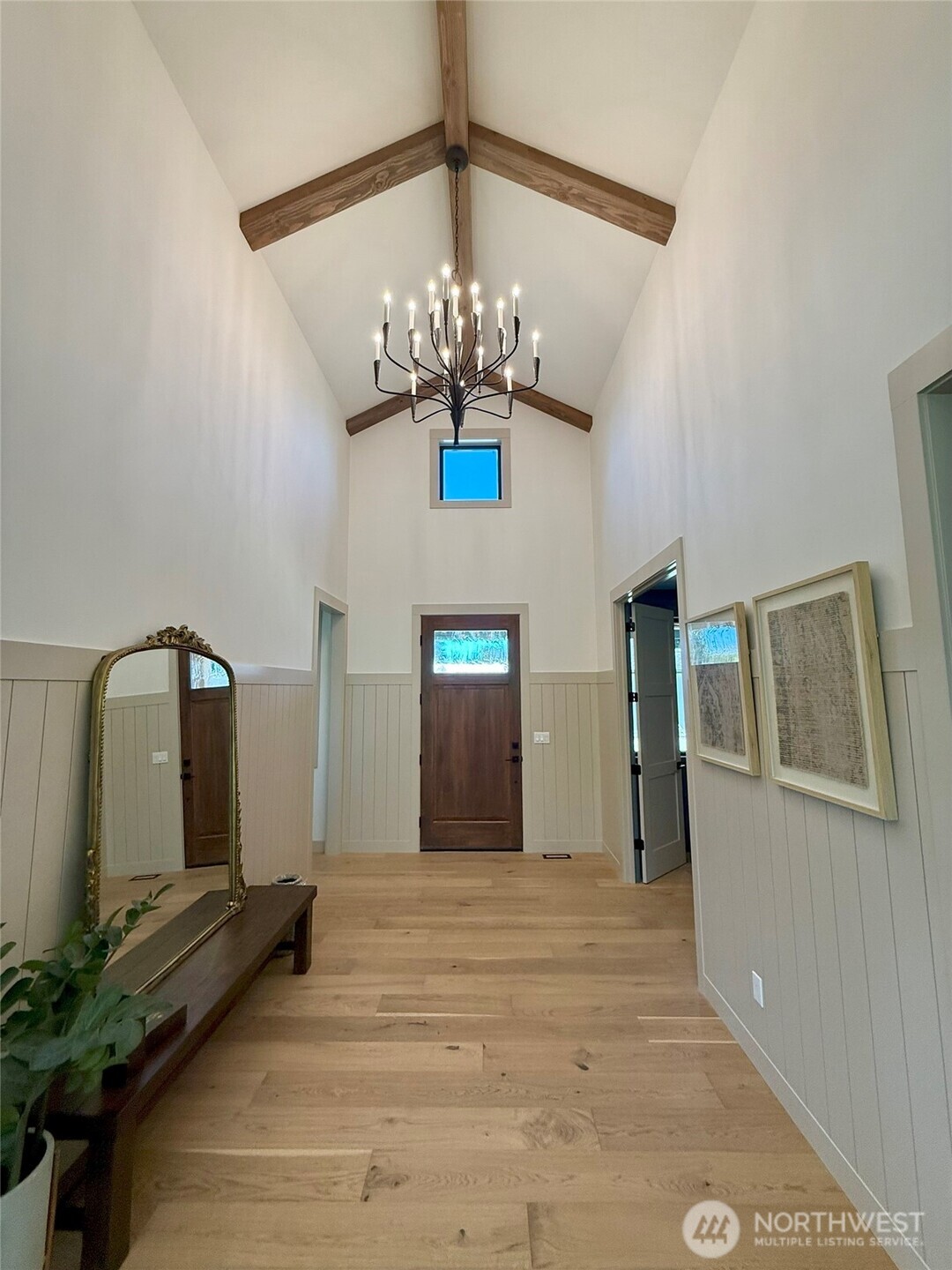 12107 Mundy Loss Road Buckley, WA 98321 - Photo 3 of 40 a view of a hallway with wooden floor and chandelier