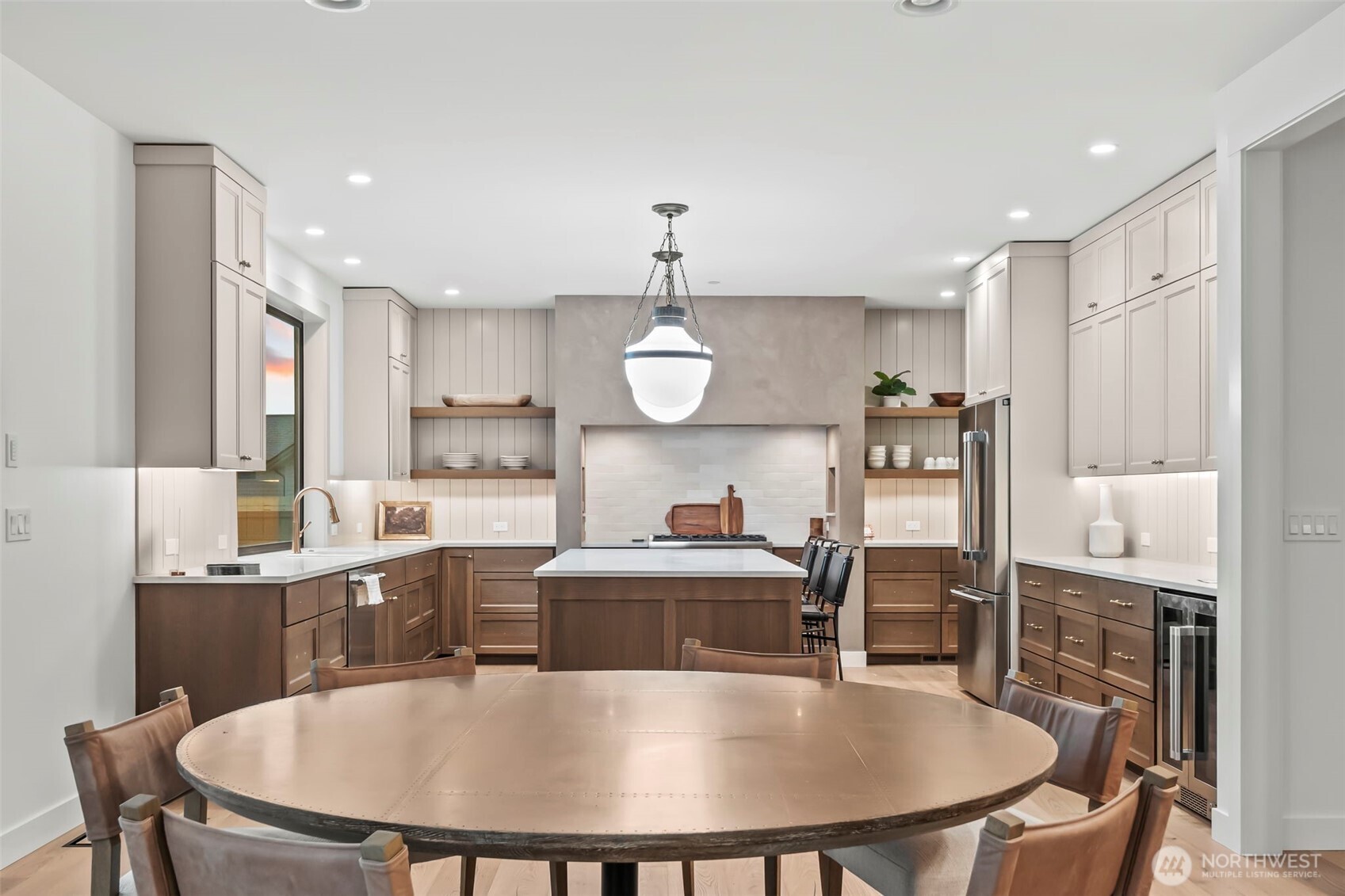 12107 Mundy Loss Road Buckley, WA 98321 - Photo 9 of 40 a kitchen with granite countertop a table chairs stove and microwave