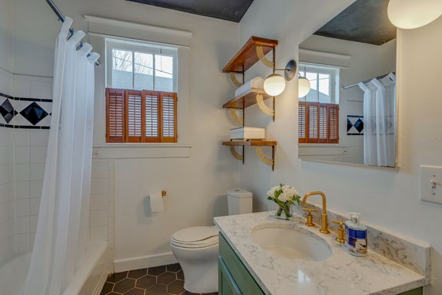 a bedroom with a bed and a night stand