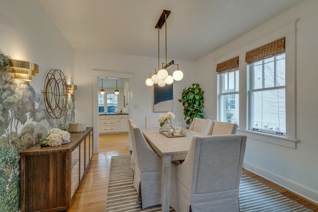 a large kitchen with granite countertop a large window a sink stainless steel appliances and cabinets