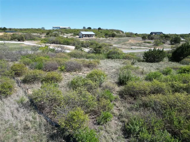 an aerial view of mountain with trees in the back