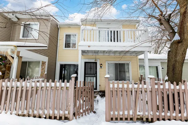a front view of a house with a fence