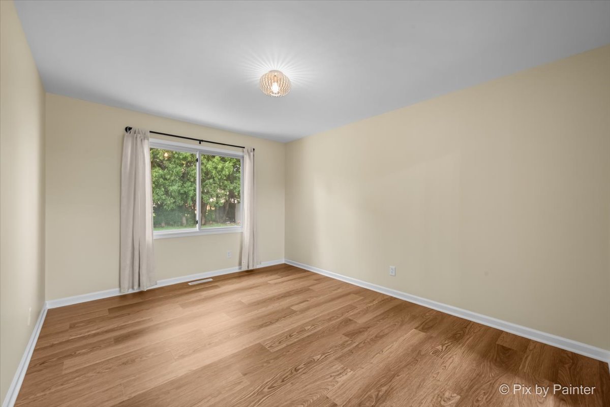 676 Concord Drive Crystal Lake, IL 60014 - Photo 12 of 38 a view of an empty room with wooden floor and a window