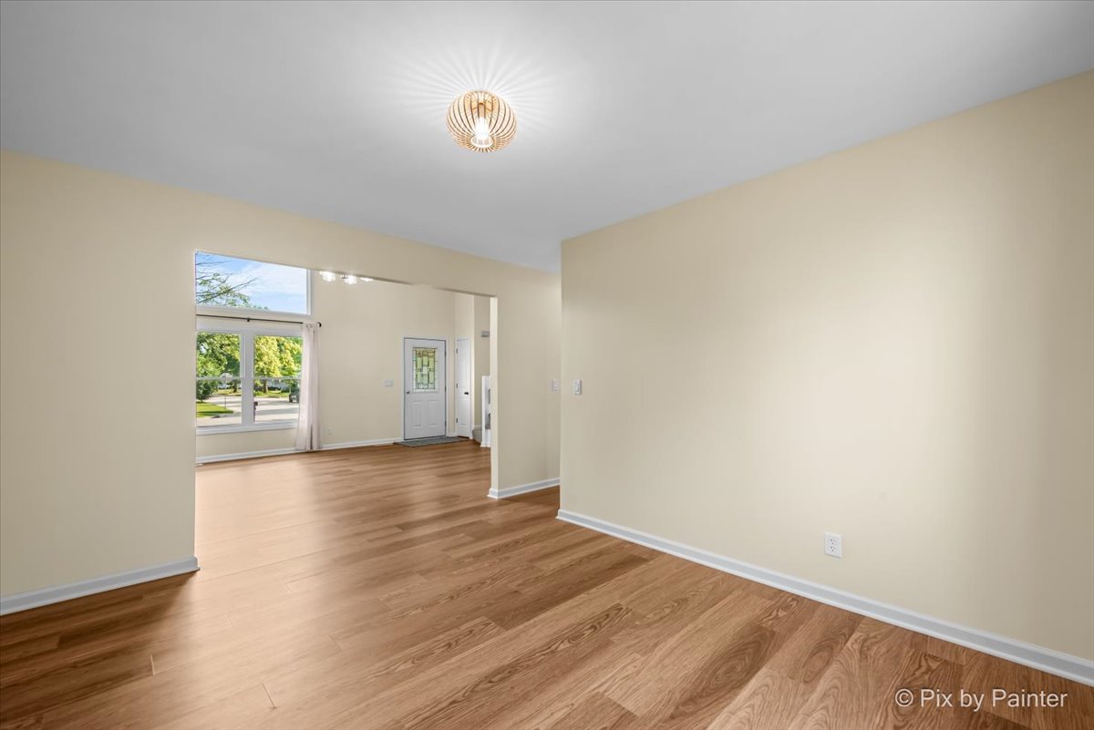 676 Concord Drive Crystal Lake, IL 60014 - Photo 13 of 38 an empty room with wooden floor and windows