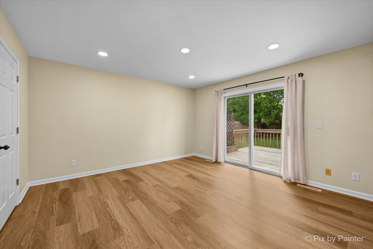 676 Concord Drive Crystal Lake, IL 60014 - Photo 14 of 38 a view of an empty room with wooden floor and a window
