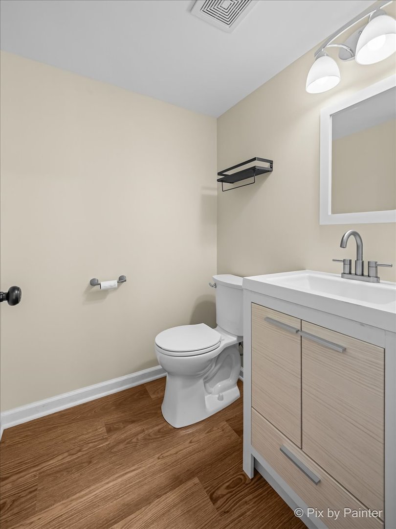676 Concord Drive Crystal Lake, IL 60014 - Photo 15 of 38 a bathroom with a toilet a sink and mirror