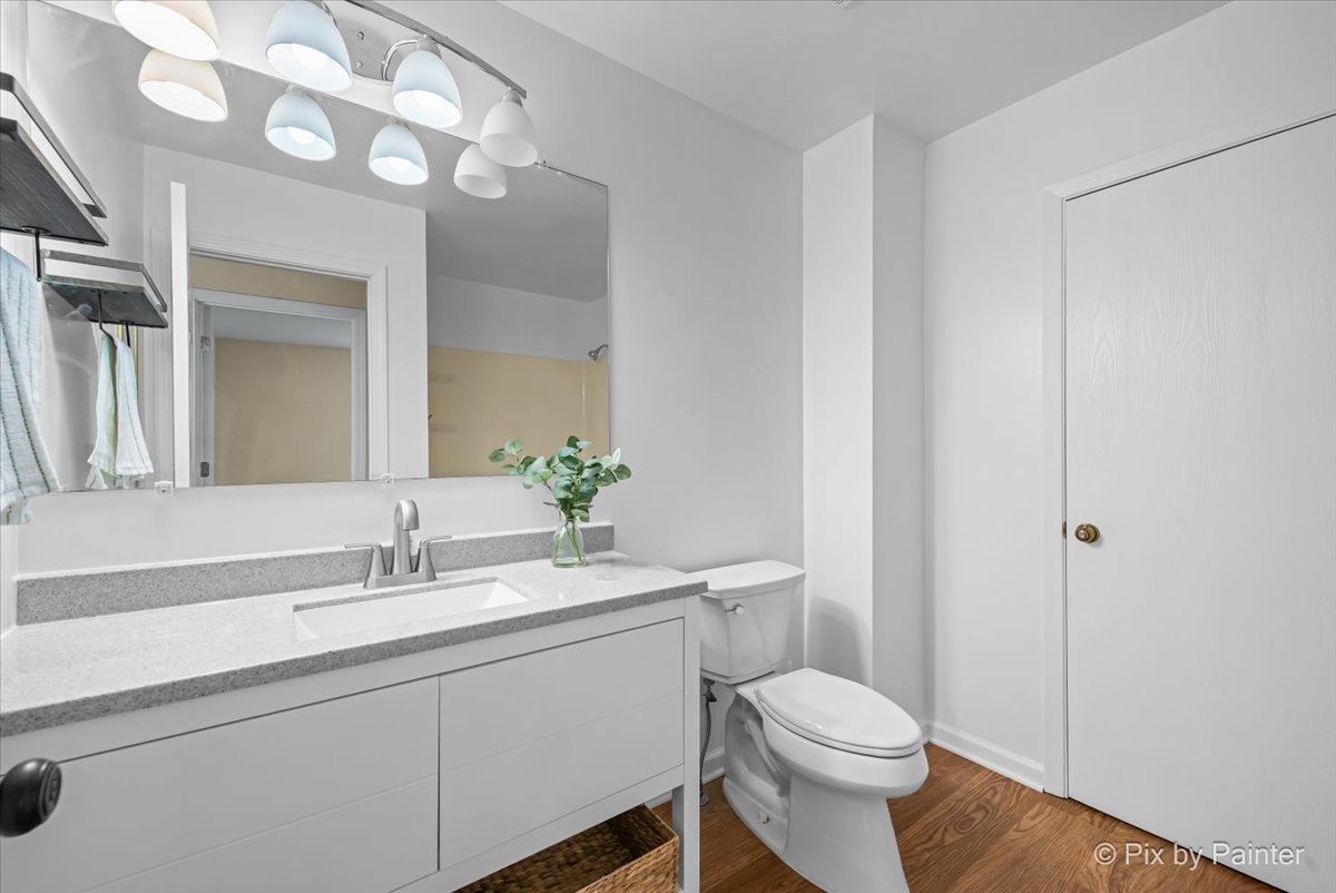 676 Concord Drive Crystal Lake, IL 60014 - Photo 20 of 38 a bathroom with a toilet sink and mirror