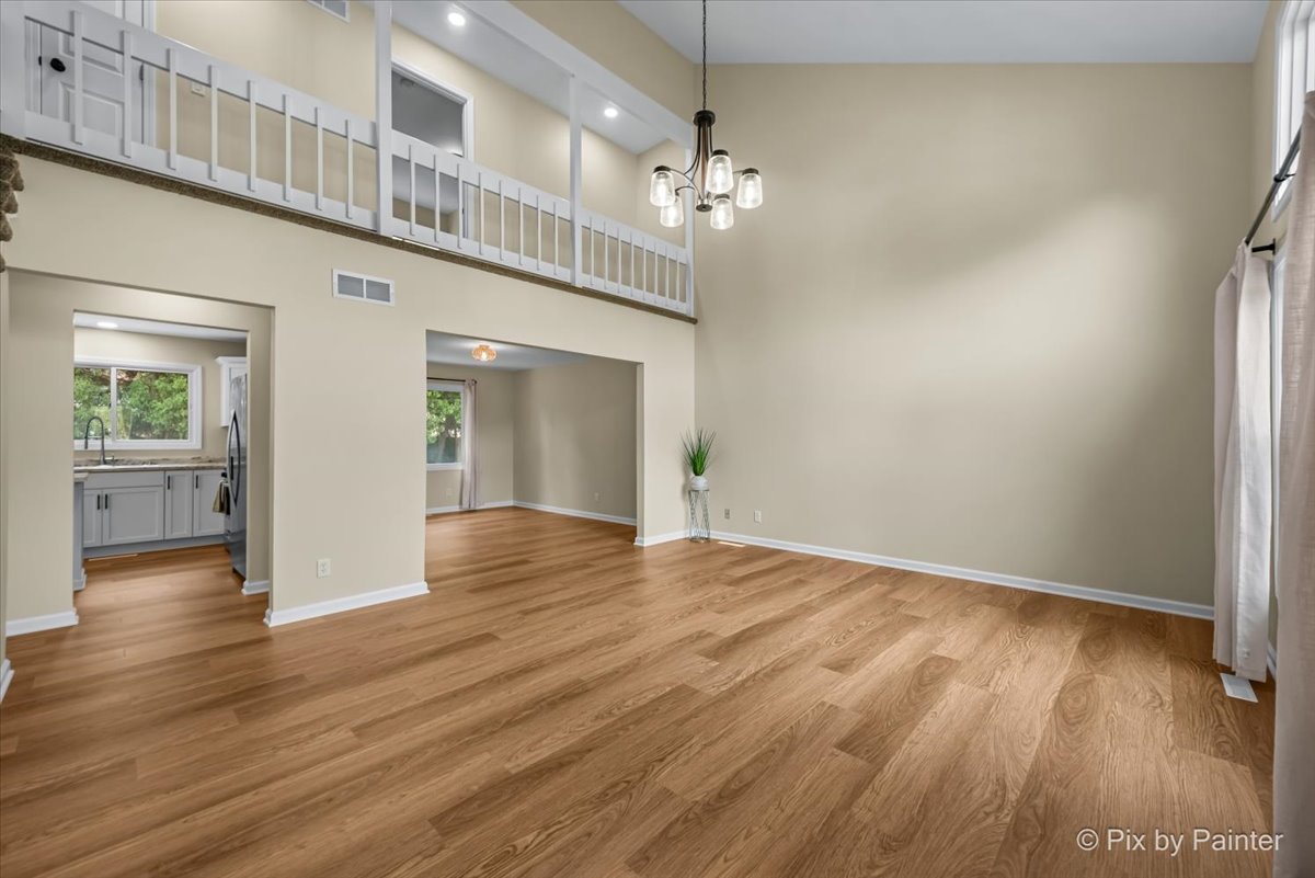 676 Concord Drive Crystal Lake, IL 60014 - Photo 3 of 38 a view of livingroom with hardwood floor and kitchen view