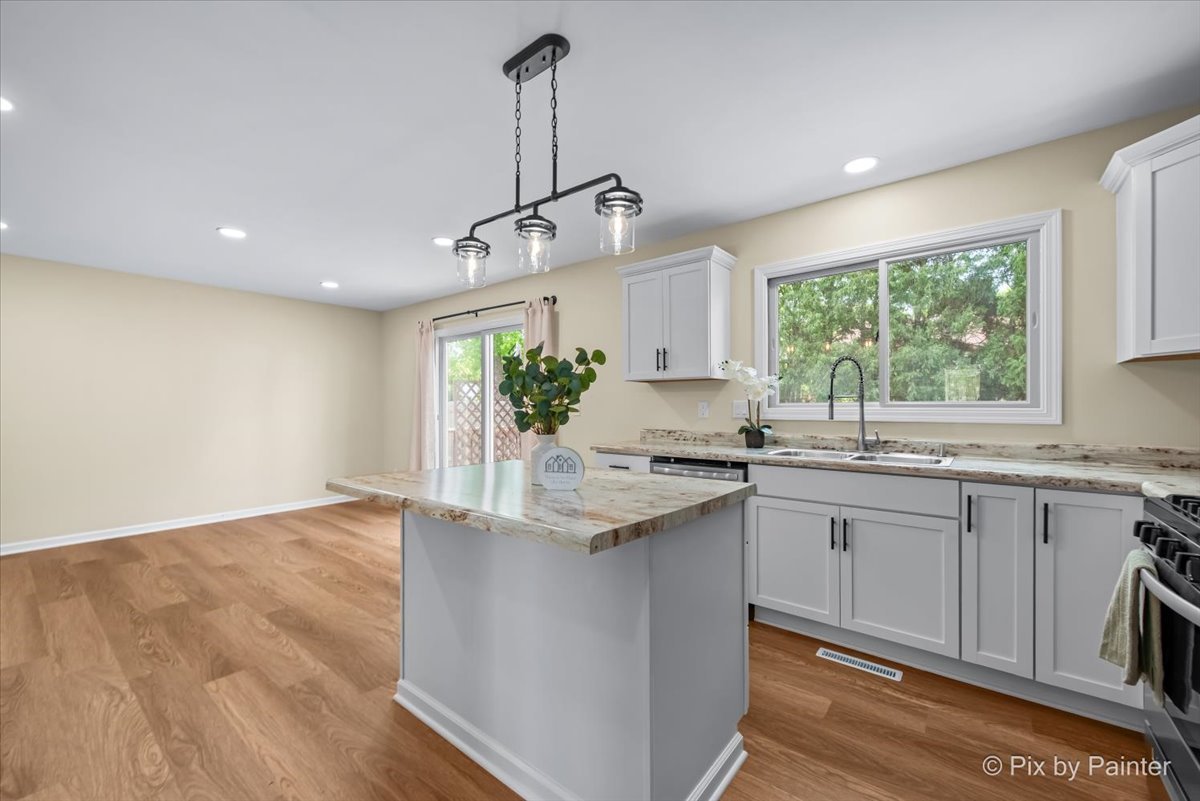 676 Concord Drive Crystal Lake, IL 60014 - Photo 7 of 38 a kitchen with granite countertop a sink cabinets and window