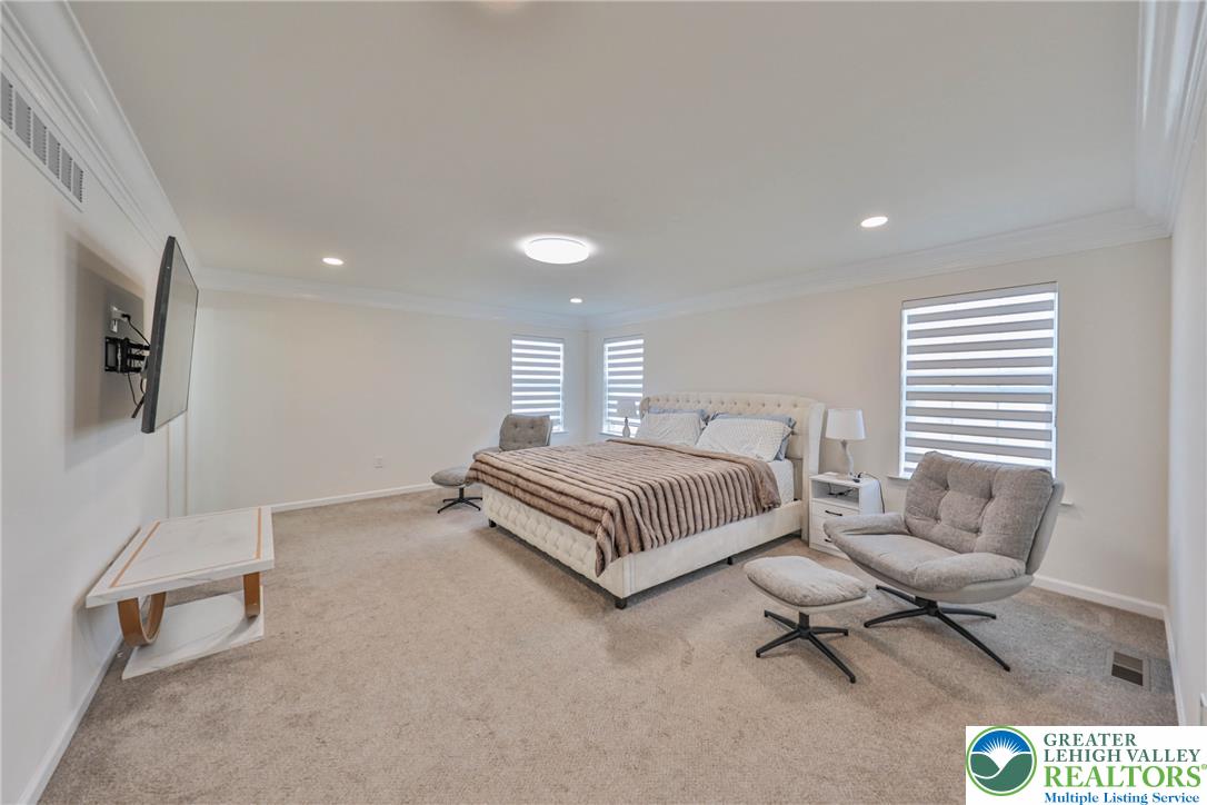 1105 Meco Road Easton, PA 18040 - Photo 44 of 100 Crown molding and soft carpeting elevate this spacious bedroom retreat.