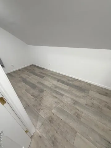 a view of kitchen and empty room