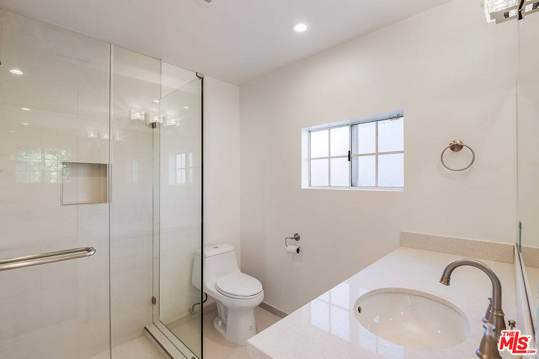 148 Le Doux Road Beverly Hills, CA 90211 - Photo 11 of 22 a white toilet sitting next to a bathroom sink