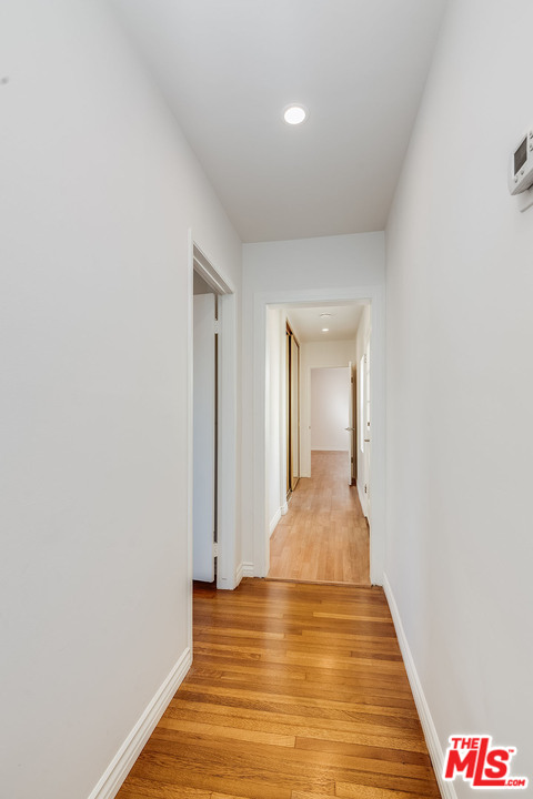 148 Le Doux Road Beverly Hills, CA 90211 - Photo 12 of 22 a view of a hallway with wooden floor