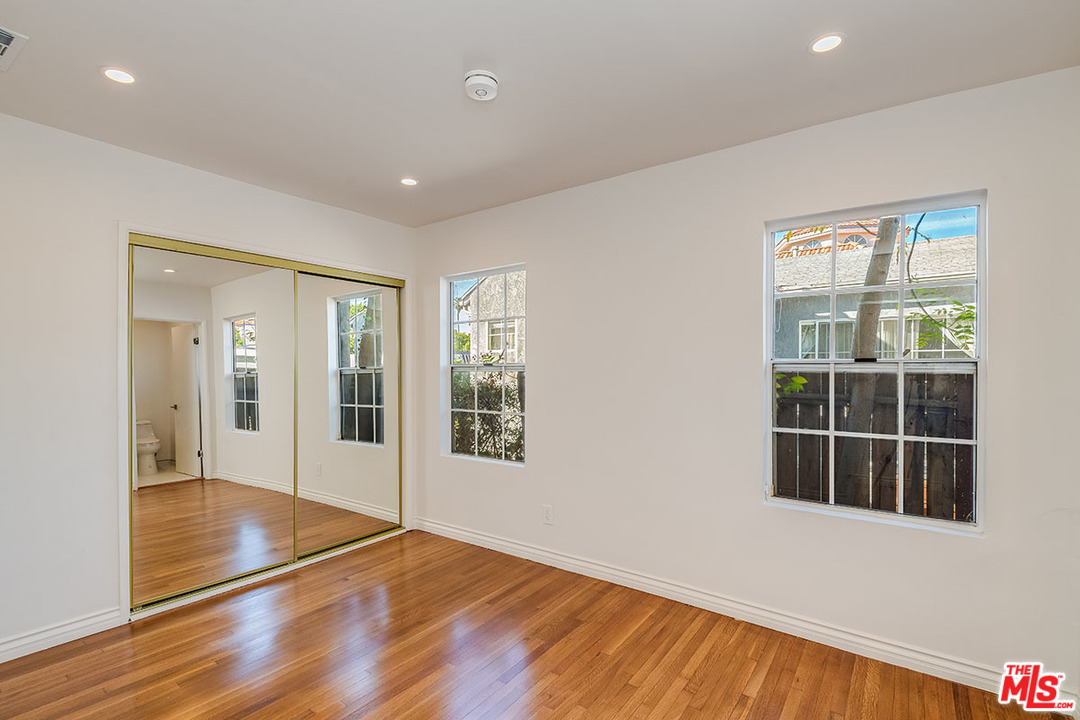 148 Le Doux Road Beverly Hills, CA 90211 - Photo 13 of 22 a view of an empty room with wooden floor and a window