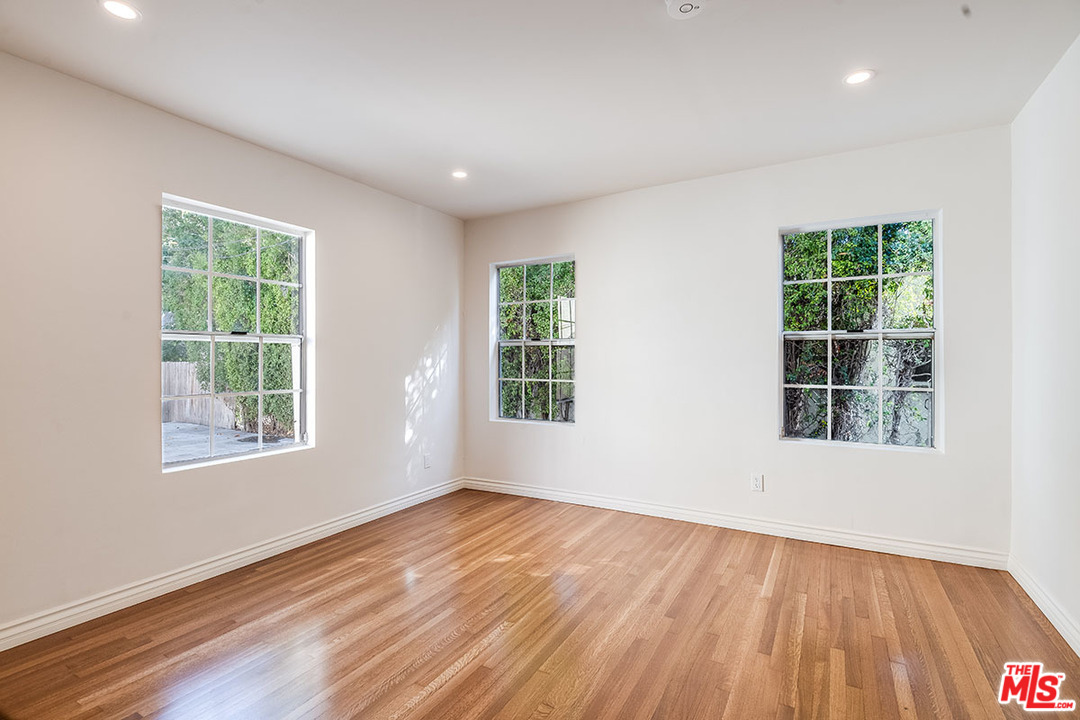 148 Le Doux Road Beverly Hills, CA 90211 - Photo 15 of 22 an empty room with wooden floor and windows