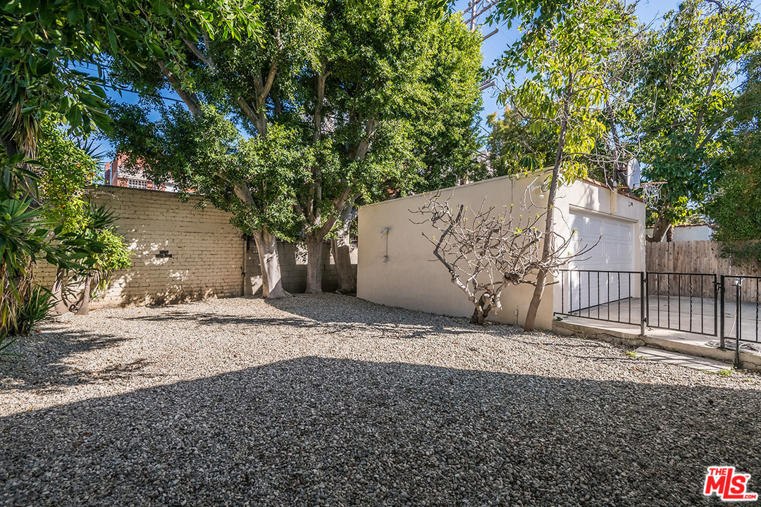 148 Le Doux Road Beverly Hills, CA 90211 - Photo 20 of 22 a backyard of a house with large trees and outdoor seating